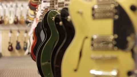 Guitars hanging in a shop Stock Footage 94641399