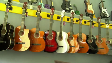 Guitars hanging on the wall Stock Footage 166863085