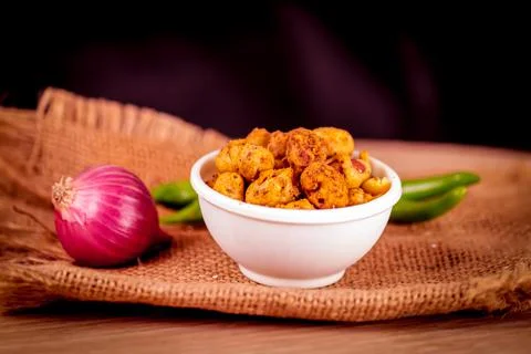 Gujarati Spiced coated fried and crunchy Masala Peanut on wooden table with o Stock Photos