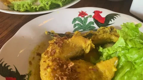 Gulai chicken is a dish from Java, Indonesia. The gulai sauce and the chicken Video stock 328071082