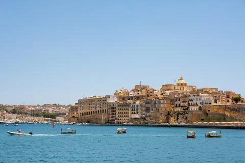 Gulf between Valletta and Vittoriosa with passing boats and typical luzzu a.. Stock Photos