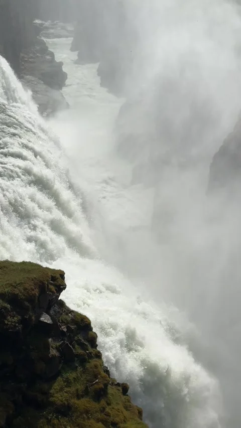 Gullfoss waterfall attracts visitors with its double-tiered cascade and dramatic Stock Footage 312232921