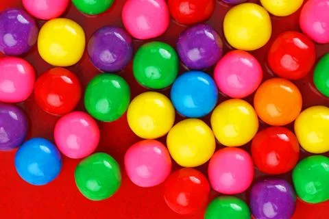 Gumballs on red ceramic Stock Photos