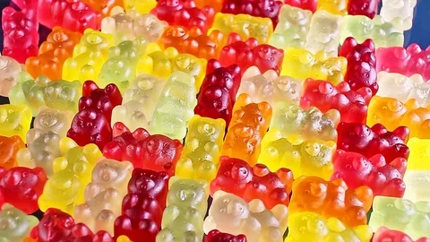 Gummy bear background. Gummy bears as texture. Gum bear candy colorful pattern. 動画素材 96368524