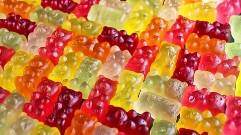 Gummy bear background. Gummy bears as texture. Gum bear candy colorful pattern. 動画素材 102743403