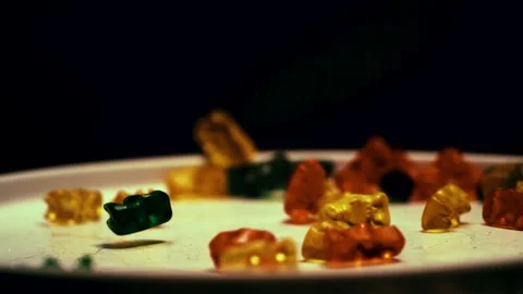 Gummy Bears Fall on Plate Stock Footage 300892587
