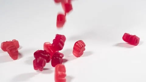 Gummy Bears falling onto a white surface in slow motion Video stock 116510316