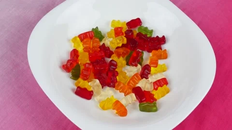 Gummy bears rotating on white Video stock 48029141