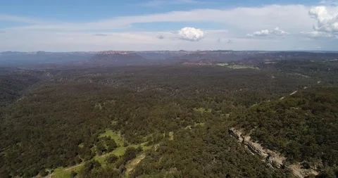 Gumtree woods in Capertee valley between mountain ranges in aerial 4k. Stock Footage 141090216