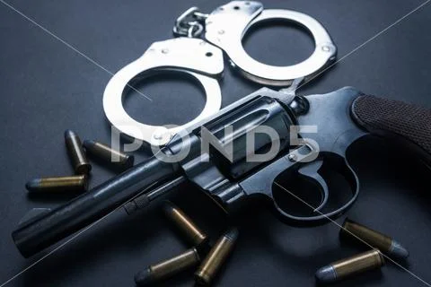 Gun with ammunition and shackle on black background Stock Photos