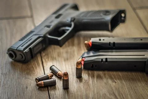 Gun and bullets Stock Photos