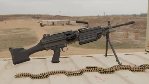 Gun and bullets on table left to right slider shot Video stock 76940405