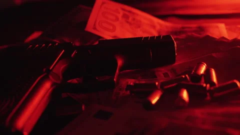 Gun and dollars in the light of flashes of police lights Stock Footage 245267461
