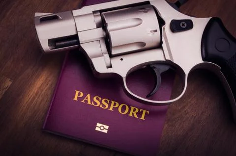 Gun and passport Stock Photos