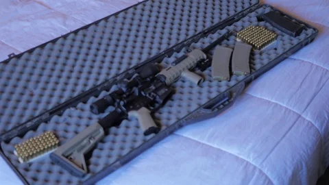 Gun case placed on a bed and opened.  Stock Footage 81466055