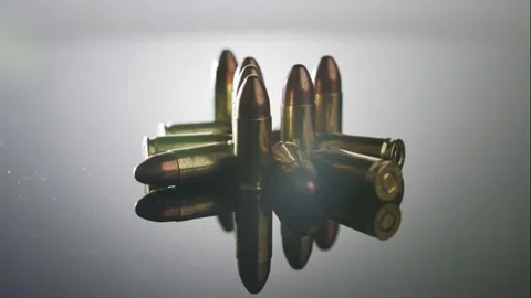 Gun Control. Ammunition of 9mm bullets rotating on a reflective surface Video stock 202907054