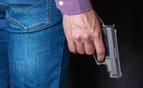 Gun control concept. Armed man holds pistol in hand Stock-Fotos