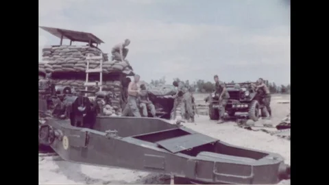 Gun Crew move towards weapon and load howitzer shells in cannon - 1960 Stock Footage 102178042