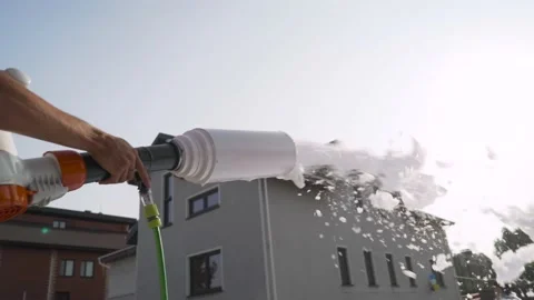 The gun fires the streams of foam on the crowd of people. Foam party on the Stock Footage 159762968