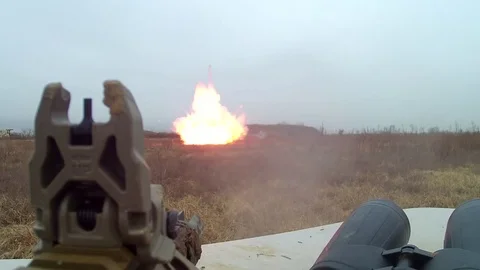 Gun firing at explosion  Video stock 76940450