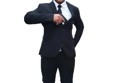 Gun man in black suit pulling pistol from gun cabinet on isolated white backg Stock Photos