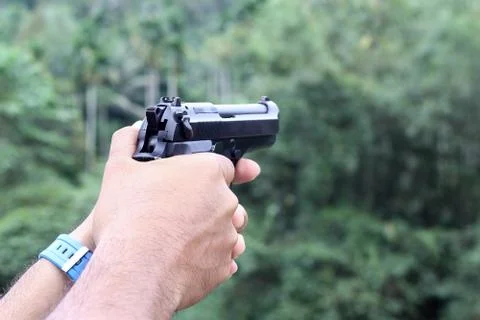 Gun in man hand Stock Photos