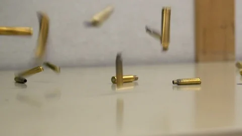 Gun Shells Falling and Bouncing on Floor Vídeo Stock 87454664