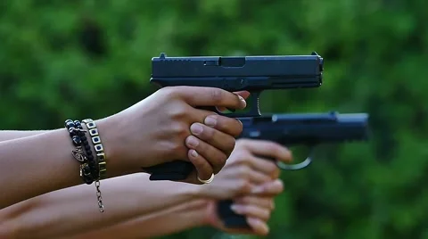 Gun shooting range two guns glocks/beretta close up shooting the same time Stock Footage