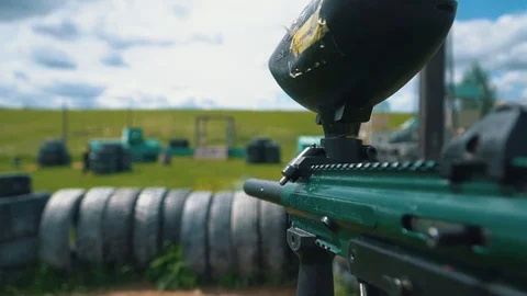 Gun shoots paint balls while playing paintball Stock Footage 115530595