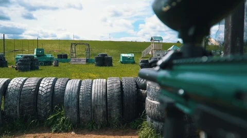 Gun shoots paint balls while playing paintball Stock Footage 116655403