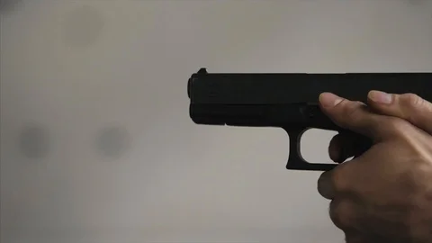 Gun is shot close-up. Pistol in hand close-up. Pistol being shot 1 times. Man Stock Footage