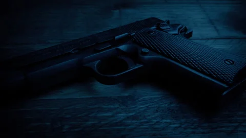 Gun On Table In Dark Room Stock Footage 276375489
