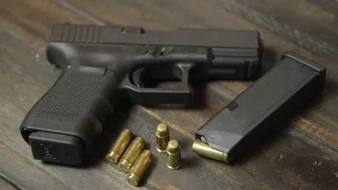 Gun on table Video stock 143977976