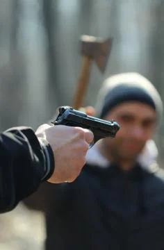 Gun verses axe Foto stock
