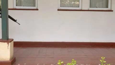 Gunman walking down school corridor with a rifle Stock Footage 106962626