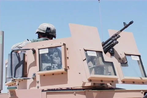 Gunner smoking and checking out enemy positions in Afghanistan NTSC Stock Footage 1214356