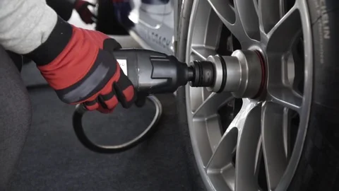 The gunner tightens the wheel nuts pit stop changing wheel in slow motion Stock Footage 124519899