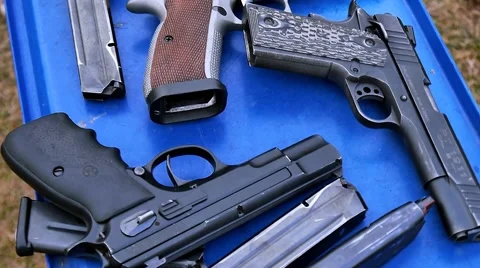 Guns on the blue table, shooting range Stock Footage 48065264