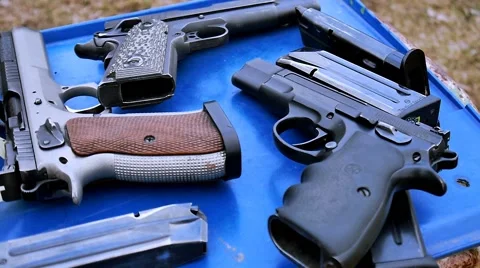 Guns on the blue table, shooting range Stock Footage 48065370
