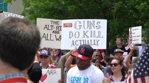 "Guns do kill actually" says protester sign during anti-gun rally in Atlanta Stock Footage 76835991