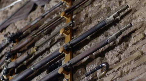 Guns lined up horizontal on Marble wall Stock Footage 67007091