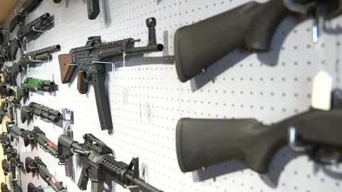 Guns on Wall in a Weapons Shop Vídeos de archivo 87454615