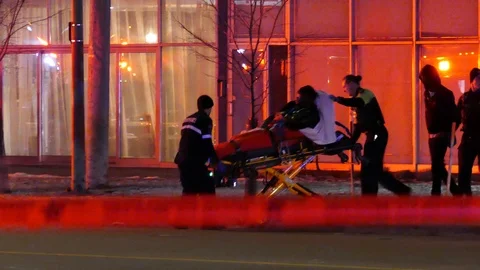 Gunshot black victim on stretcher during the night Stock Footage