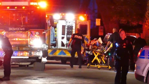 Gunshot victim on stretcher with emergency crew Stock Footage