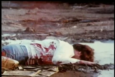 Gunshots hitting bleeding man on ground Vídeos de archivo 11345513