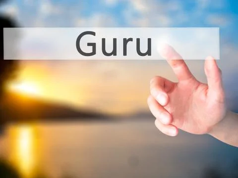 Guru - Hand pressing a button on blurred background concept on visual screen. Stock Photos