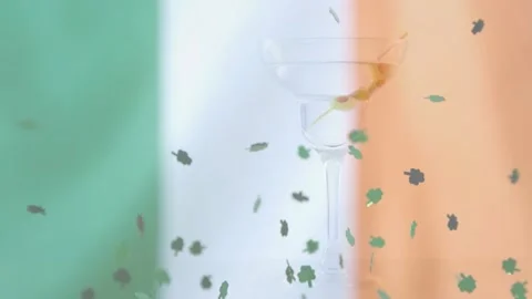 Gust sparking shamrocks swirling, falling over tricolor revealing goblet outline Stock Footage 329505518