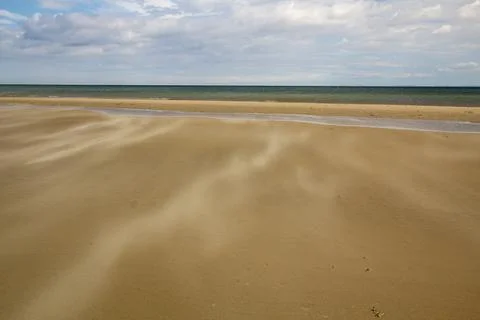 A gust of wind blowing over the beach Foto stock