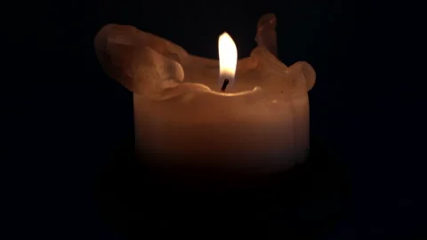 A gust of wind extinguishes the flame of the candle burning in the dark night. Stock Footage 237153838