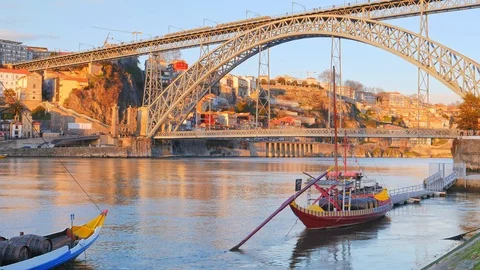 Gustave Eiffel Bridge and town cityscape on the Douro River with Rabelo boats Stock Footage 117281258